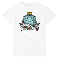 A white t-shirt displays a colorful illustration of a D20 die surrounded by flowers and a banner reading "That's How I Roll," referencing the tabletop game Dungeons & Dragons.