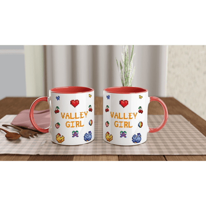 Two white coffee mugs feature pixel art designs inspired by Stardew Valley, including chickens, cherries, and the words "Valley Girl.