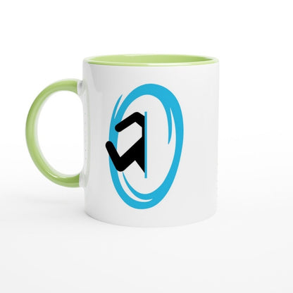 A white ceramic mug with a green handle and rim features a blue Portal symbol from the Half-Life video game.