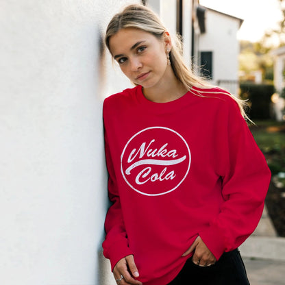 Person wearing a red 'Nuka Cola' sweatshirt outdoors.