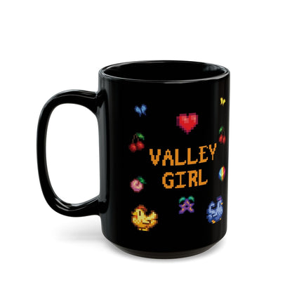 A black coffee mug displays pixel art sprites / graphics from Stardew Valley including a heart, cherries, a prismatic shard, a stardrop, and butterflies.