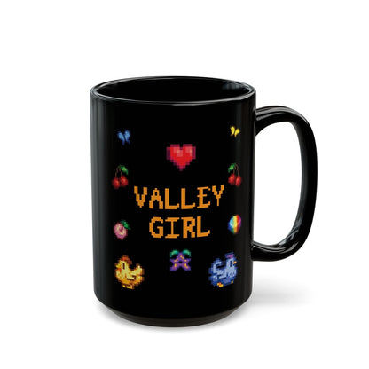 A black coffee mug displays pixel art sprites / graphics from Stardew Valley including a heart, cherries, a prismatic shard, a stardrop, and butterflies.