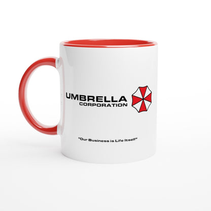 A white mug features a red interior and handle displaying the Umbrella Corporation logo and the phrase "Our Business is Life Itself" referencing Resident Evil.
