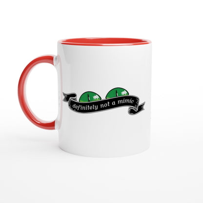 A white mug with a red handle and rim features a Dungeons & Dragons mimic illustration and the words "definitely not a mimic" on a banner.