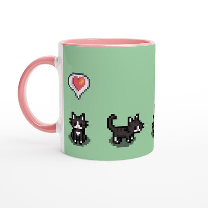 A white mug with a pink handle features pixel art of tuxedo cats and a heart emote from Stardew Valley.