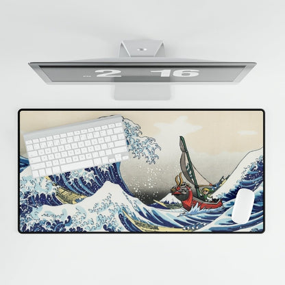 A large desk mat depicts Link from Zelda: Wind Waker sailing through a stylized version of The Great Wave.