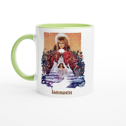 A white mug features a graphic design from the 1986 fantasy movie Labyrinth depicting Jareth the Goblin King and Sarah in front of a labyrinth pattern, with "Labyrinth" printed at the bottom.