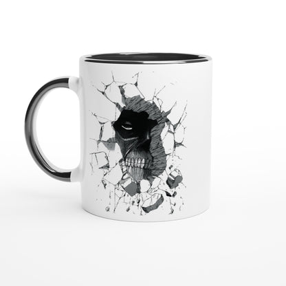 A white ceramic mug depicts a black and gray illustration of the Colossal Titan from Attack on Titan breaking through a wall.