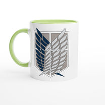 A white ceramic mug featuring the Wings of Freedom emblem from Attack on Titan is displayed against a plain background.
