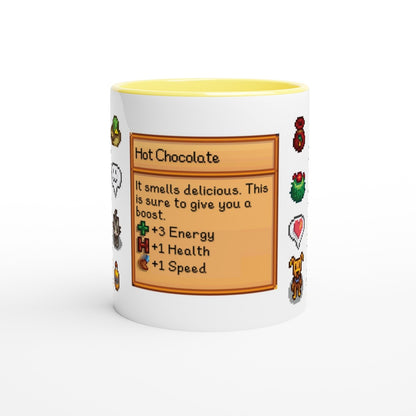A white mug trimmed with yellow features a Stardew Drinks pattern depicting a hot chocolate beverage card with pixelated sprites and stats for energy, health, and speed.