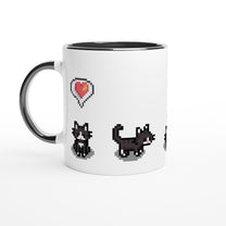 A white mug displays pixelated graphics of tuxedo cats and a heart emote referencing the Stardew Valley game.