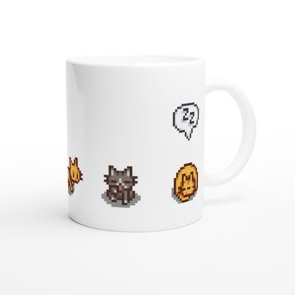 A white mug displays pixelated graphics of a ginger cat, tabby cat, gold coin, and speech bubble from the Stardew Valley computer game.