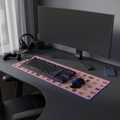 A pink desk mat featuring pixel art animals from Stardew Valley sits on a dark desk alongside a keyboard, mouse, and gaming accessories.
