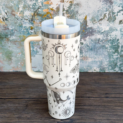 A white Witchy Boho engraved tumbler features celestial designs including stars, moons, and crystals.