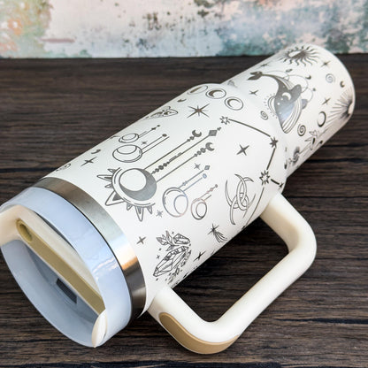 A white Witchy Boho engraved tumbler features celestial magic designs including stars, moons, and crystals.