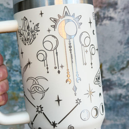 A white Witchy Boho engraved tumbler displays celestial magic imagery including stars, moons, and crystals in a silver metallic design.