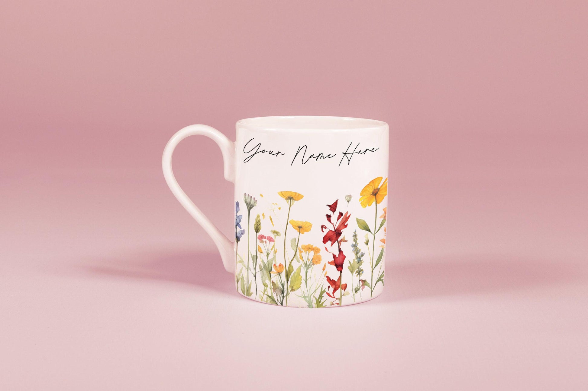 A white china mug features a watercolour floral design of wildflowers and personalized text reading "Your Name Here".