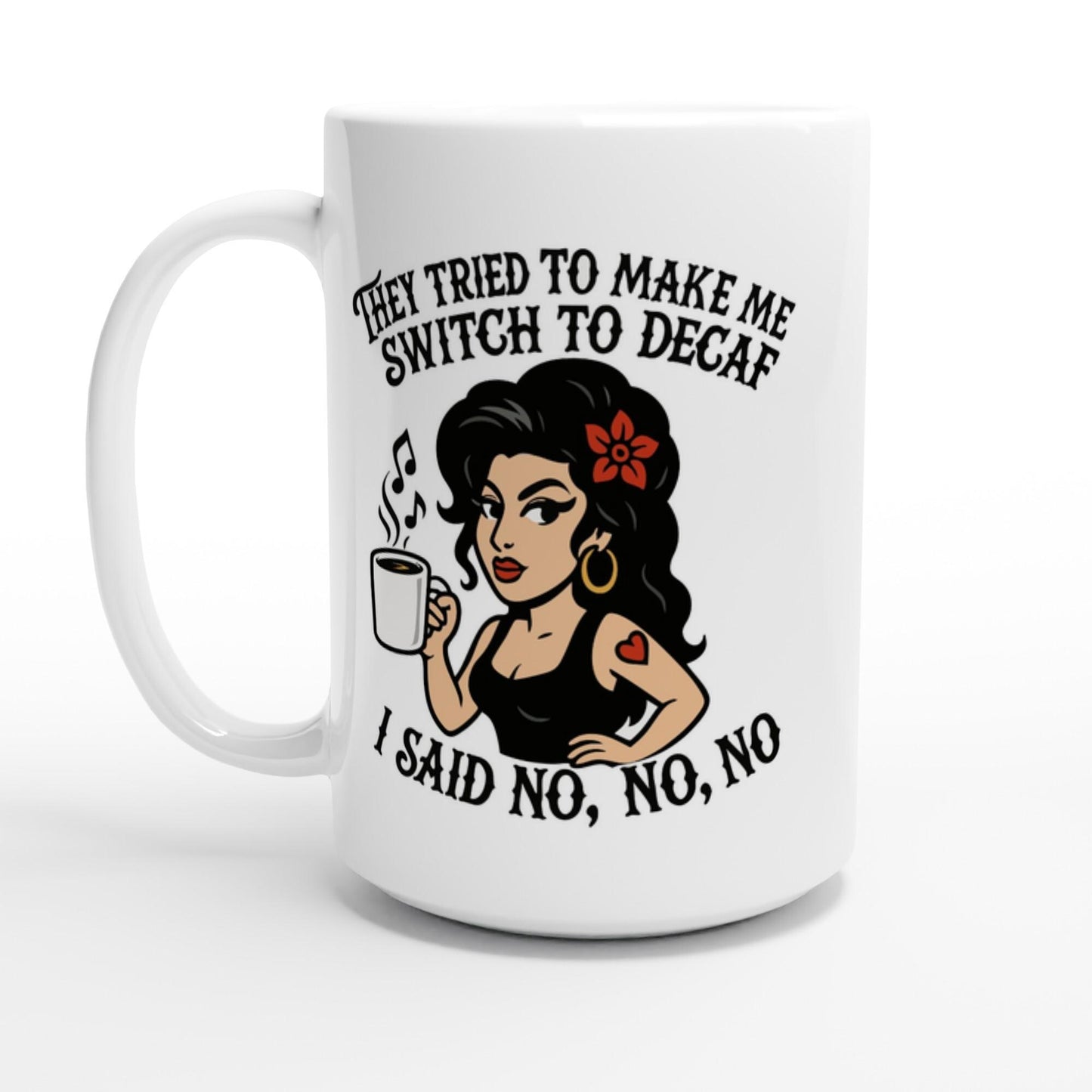 A white coffee mug displays an illustration of Amy Winehouse holding a cup and text referencing her "No to Decaf" stance.