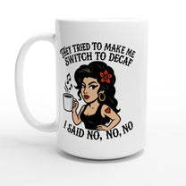 A white coffee mug displays an illustration of Amy Winehouse holding a cup and text referencing her "No to Decaf" stance.
