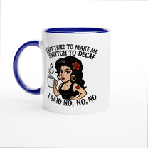 A white coffee mug with a blue interior and handle features an illustration of Amy Winehouse holding a cup and text reading "They tried to make me switch to decaf, I said no, no, no.