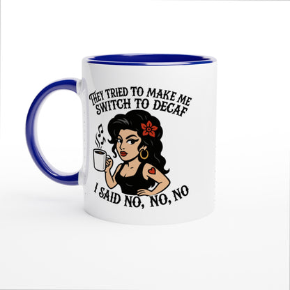 A white coffee mug with a blue interior and handle features an illustration of Amy Winehouse holding a cup and text reading "They tried to make me switch to decaf, I said no, no, no.