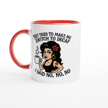 A white coffee mug with a red interior and handle features an illustration of Amy Winehouse holding a cup while text reads "They tried to make me switch to decaf, I said no, no, no.