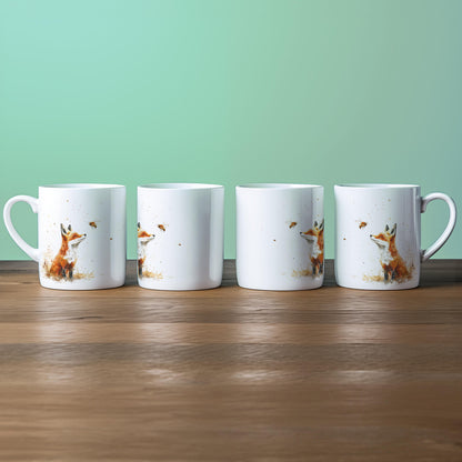 Four white china mugs display a watercolour illustration of a fox alongside a bee.