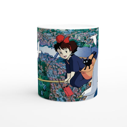 Kiki from Kiki's Delivery Service flies over Koriko on a broomstick with her cat Gigi and a seagull, as depicted in this Studio Ghibli inspired design.