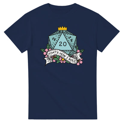 A navy blue t-shirt displays a D20 die surrounded by floral elements and a banner reading "That's How I Roll," referencing the tabletop game Dungeons & Dragons.