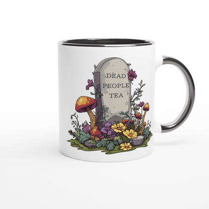 A white ceramic mug features an illustration of a tombstone surrounded by flowers and mushrooms, displaying "Dead People Tea" in text.
