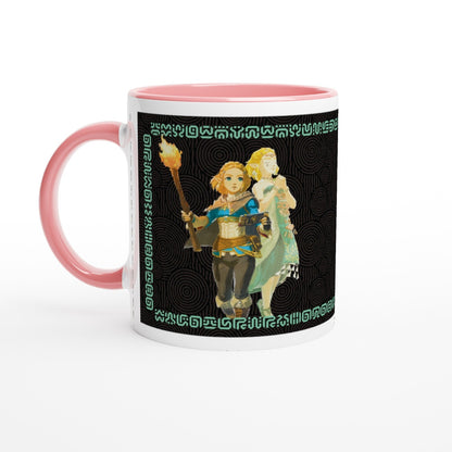 A ceramic mug displays an illustration of Link from The Legend of Zelda: Tears of the Kingdom alongside a character in green, surrounded by Sheikah script patterns.