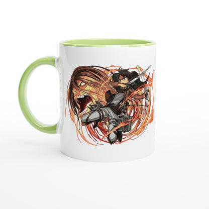 A white ceramic mug featuring an illustration of Eren Yeager from Attack on Titan wielding a sword against a titan background, with a green handle and rim.