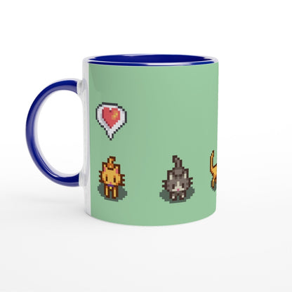 A white mug with a blue handle and rim displays pixelated graphics of ginger and tabby cats and emotes from Stardew Valley.
