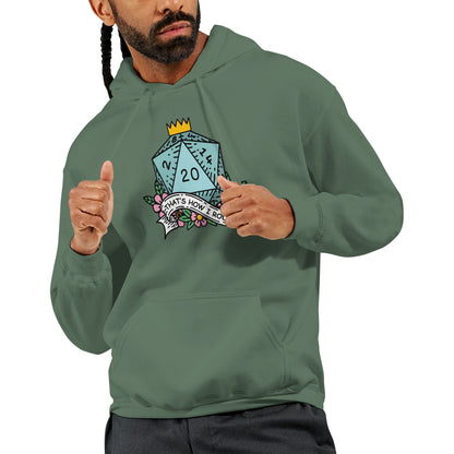 A man wearing a green D&D hoodie displays a graphic of a D20 die with floral accents and the phrase "That's How I Roll" printed on it.
