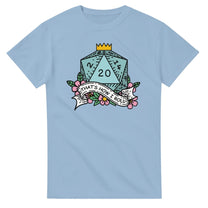 A light blue t-shirt displays a D20 die surrounded by flowers and a banner reading "That's How I Roll," referencing the tabletop game Dungeons & Dragons.