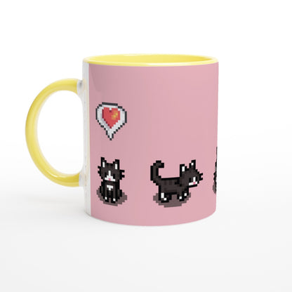 A white mug with a yellow handle features pixelated graphics of tuxedo cats and a heart emote from Stardew Valley on a pink background.
