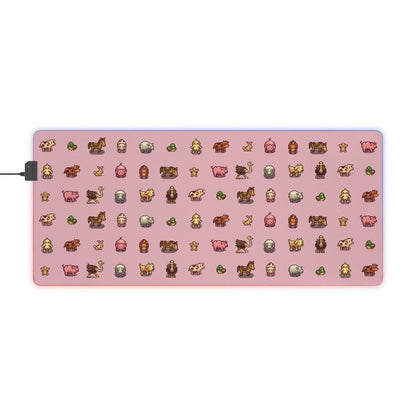 A pink desk mat features pixel art depictions of animals from Stardew Valley and has an illuminated edge.
