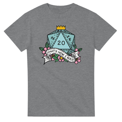 A gray t-shirt displays a D20 die surrounded by floral elements and a banner reading "That's How I Roll," referencing the D&D game.