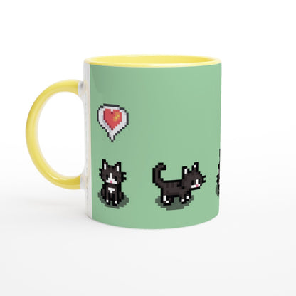 A yellow mug displays pixelated graphics from Stardew Valley featuring tuxedo cats and a heart emote.
