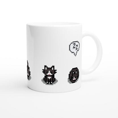 A white mug displays pixelated graphics of tuxedo cats and emotes from Stardew Valley.