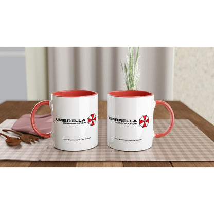 Two white mugs with red interiors display the Umbrella Corporation logo and the phrase "Our Business is Life Itself" referencing the Resident Evil franchise.
