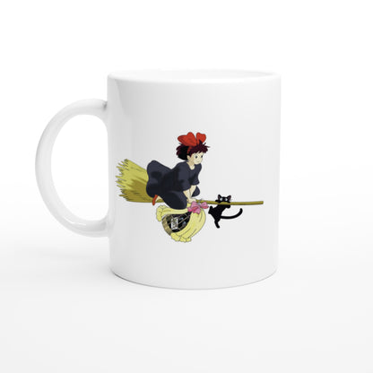 A white mug displays an illustration of Kiki from Kiki's Delivery Service riding a flying broomstick with her cat Gigi.