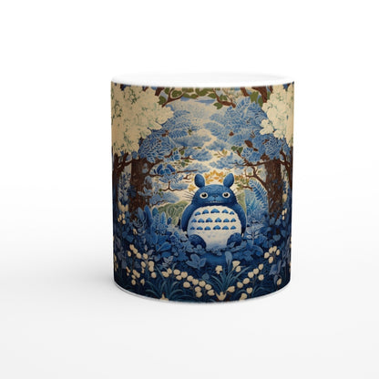 The ceramic mug depicts Totoro from Studio Ghibli standing within a chinoiserie-style cherry blossom forest scene rendered in shades of blue and cream.