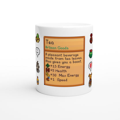 A white mug displays a Stardew Drinks pattern featuring a beverage card for tea with pixelated sprites and details about its energy-boosting properties.