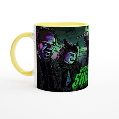 A ceramic mug displays a stylized illustration of Laszlo and Nadja from What We Do In The Shadows.