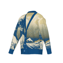 A blue knit cardigan featuring a Japanese art inspired design of the Great Wave and Mount Fuji.