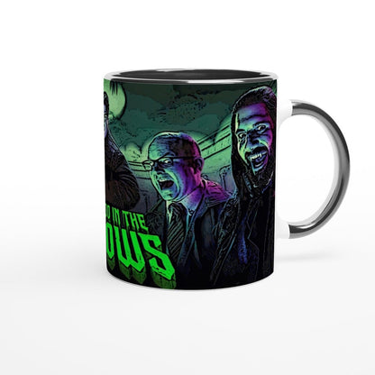 The mug features a stylized graphic of characters from What We Do In The Shadows including Laszlo, Nandor, and Guillermo against a dark green background.
