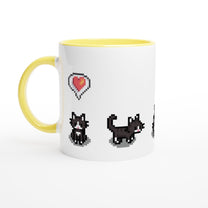 A white mug with a yellow handle and rim features pixelated graphics of tuxedo cats and a heart related to the Stardew Valley computer game.