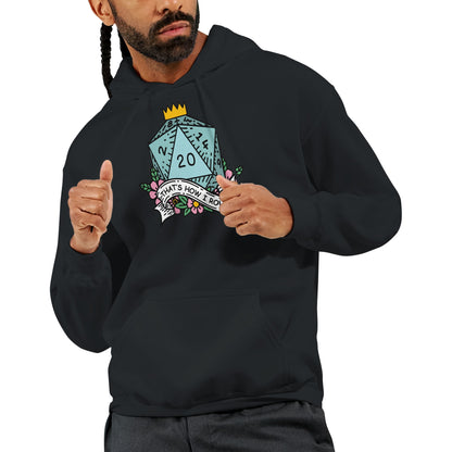A person wearing a black D&D hoodie displays a graphic of a D20 die topped with a crown and surrounded by flowers, accompanied by the phrase "That's How I Roll.