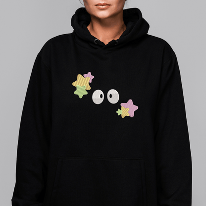 A black hooded sweatshirt features embroidered Soot Sprites inspired by Studio Ghibli designs across the chest.